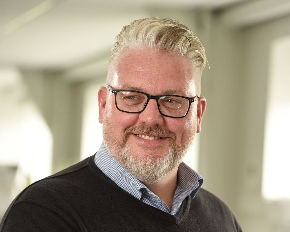 Business headshot in office male with glasses