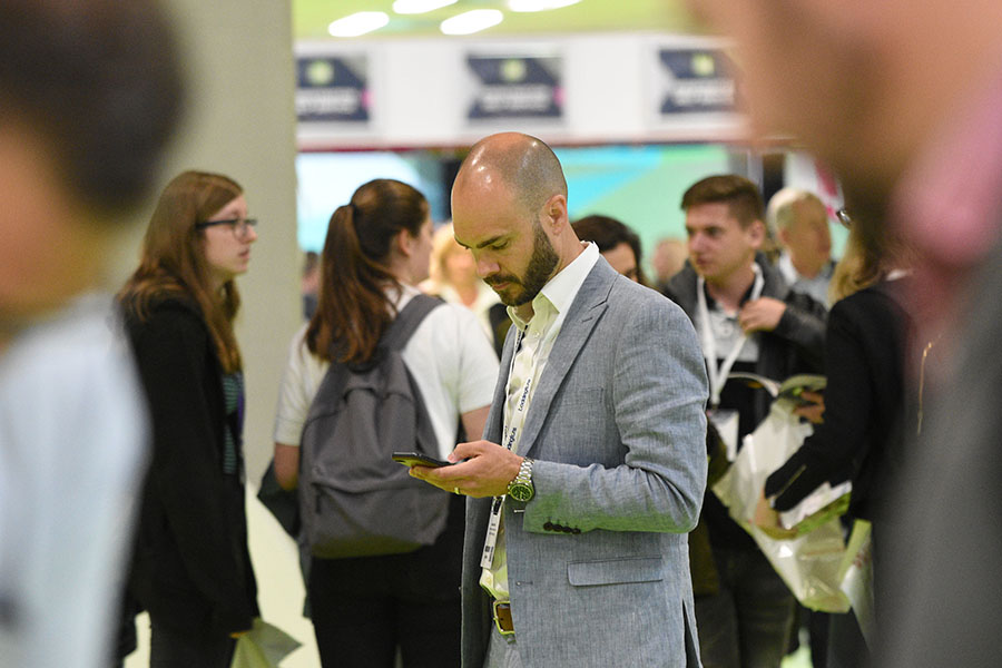 Man on phone at exhibition