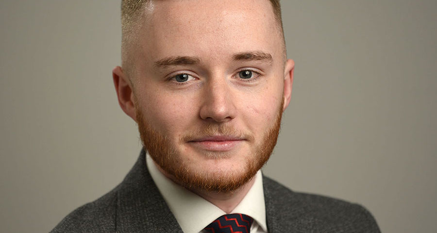 Business headshot on grey