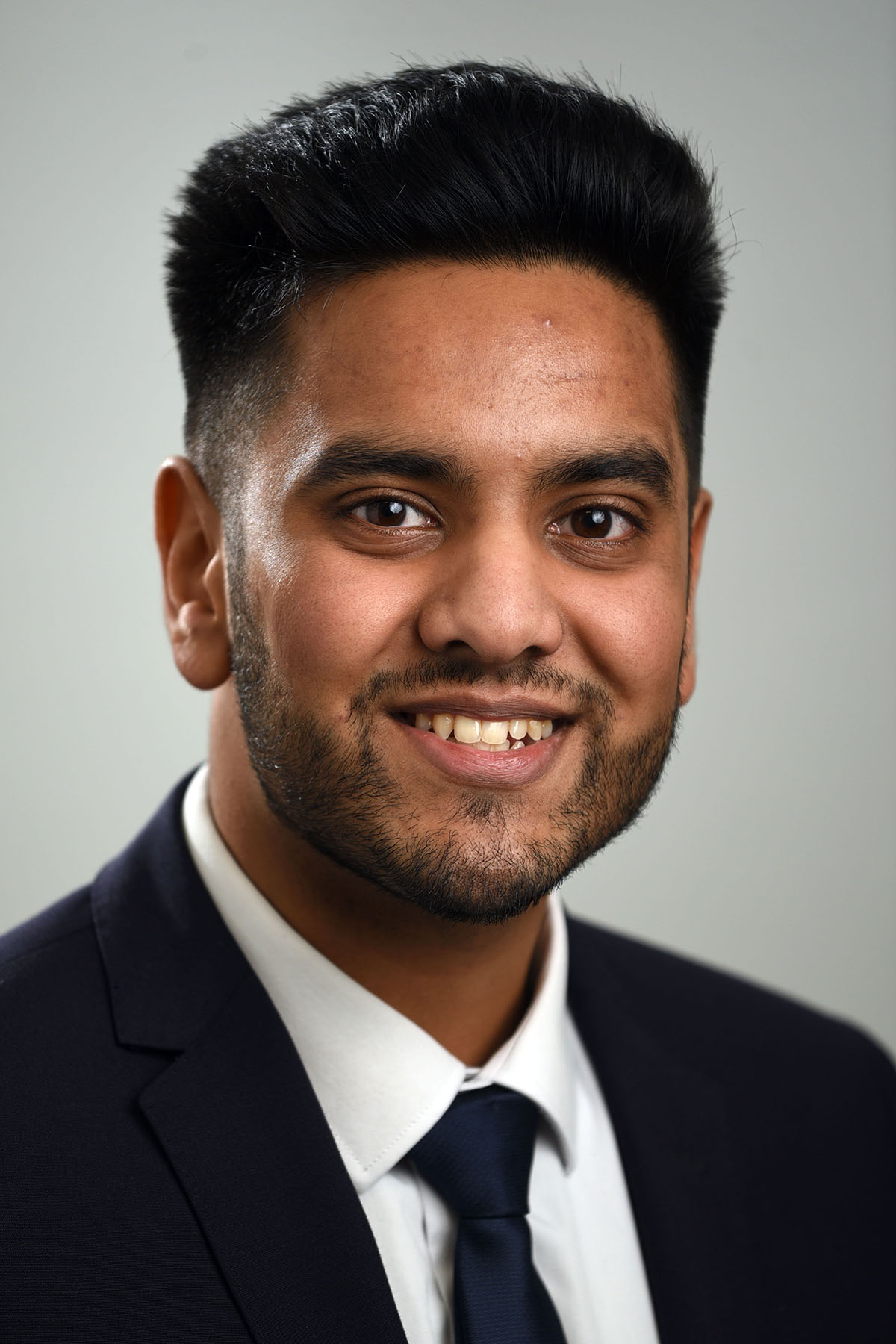 Male headshot graduated grey background